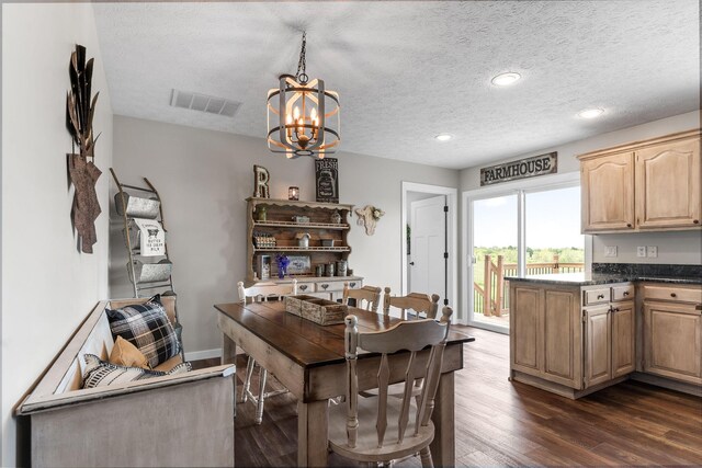 dining area featuring dark wood-type flooring, a chandelier, a textured ceiling, and recessed lighting