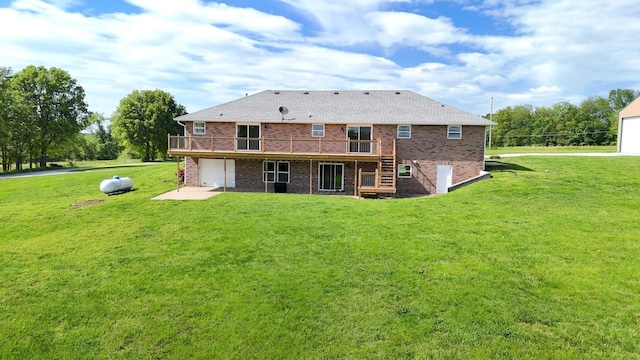 rear view of house with a garage, a wooden deck, brick siding, and a lawn