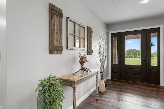foyer entrance featuring baseboards, wood finished floors, a textured ceiling, and recessed lighting