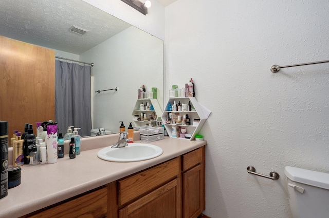 6004 N 6th Ave, Ozark, MO 65721 - bathroom with toilet, vanity, a shower with curtain, and a textured ceiling