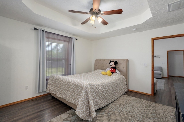 6004 N 6th Ave, Ozark, MO 65721 - bedroom with wood finished floors, a tray ceiling, baseboards, and ceiling fan