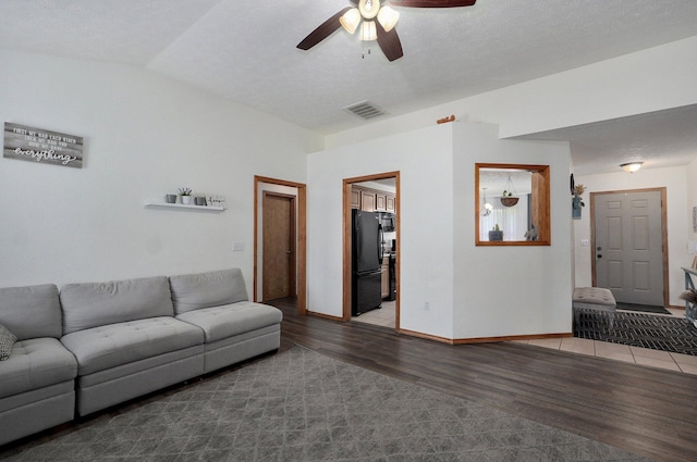 6004 N 6th Ave, Ozark, MO 65721 - living area featuring wood finished floors, a ceiling fan, vaulted ceiling, and baseboards