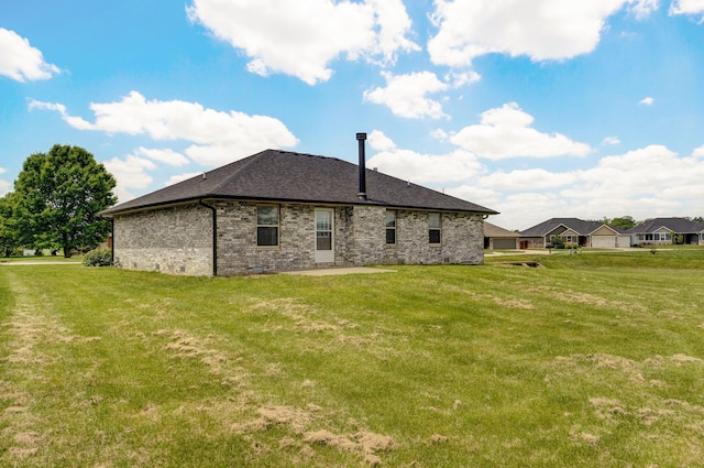 6004 N 6th Ave, Ozark, MO 65721 - back of house with a lawn, brick siding, a shingled roof, and a patio area