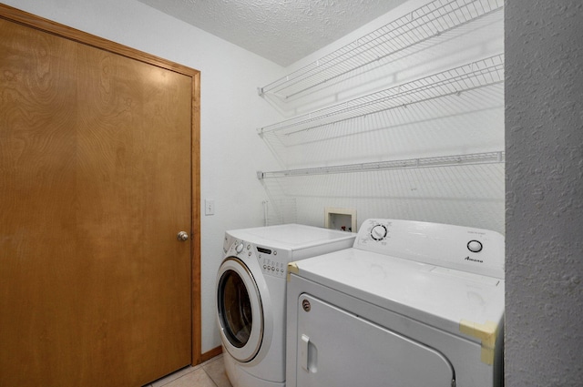 6004 N 6th Ave, Ozark, MO 65721 - washroom with washing machine and dryer, a textured ceiling, and light tile patterned flooring