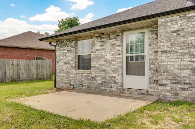 6004 N 6th Ave, Ozark, MO 65721 - view of exterior entry featuring a shingled roof, a patio, and brick siding