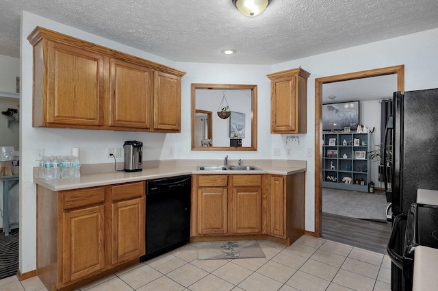 6004 N 6th Ave, Ozark, MO 65721 - kitchen with black appliances, a sink, brown cabinetry, light countertops, and light tile patterned flooring