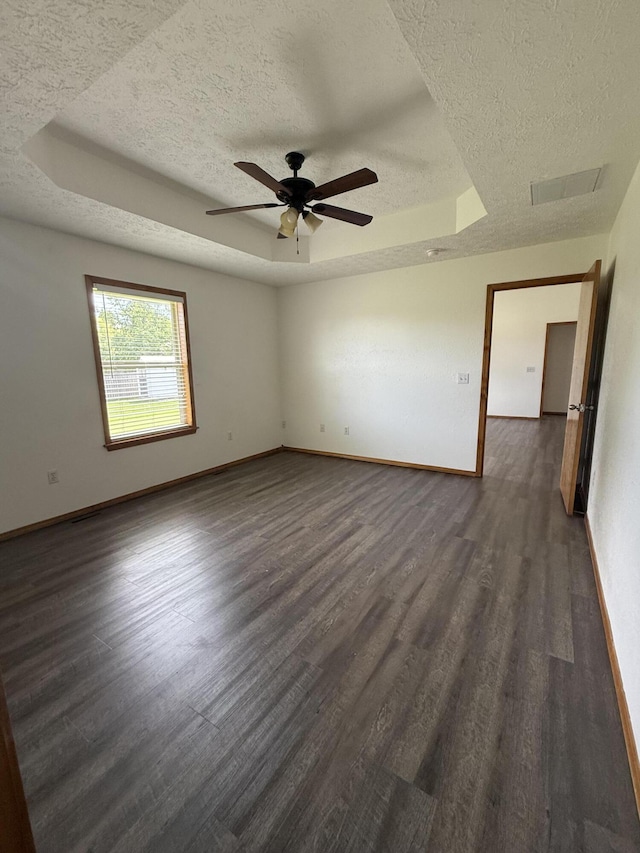6004 N 6th Ave, Ozark, MO 65721 - unfurnished room with a textured ceiling, a raised ceiling, dark wood-style flooring, baseboards, and ceiling fan