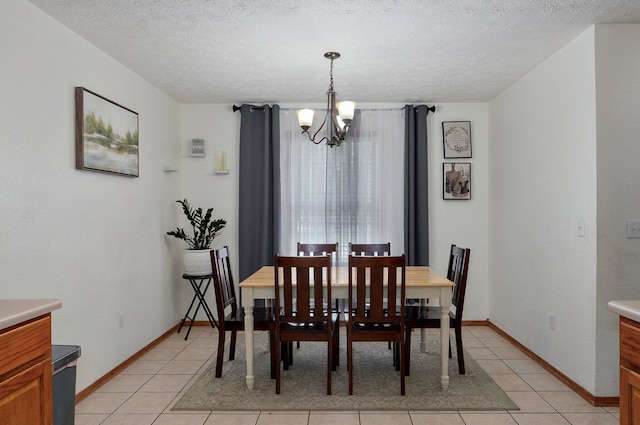 6004 N 6th Ave, Ozark, MO 65721 - dining room with a chandelier, light tile patterned floors, a textured ceiling, and baseboards