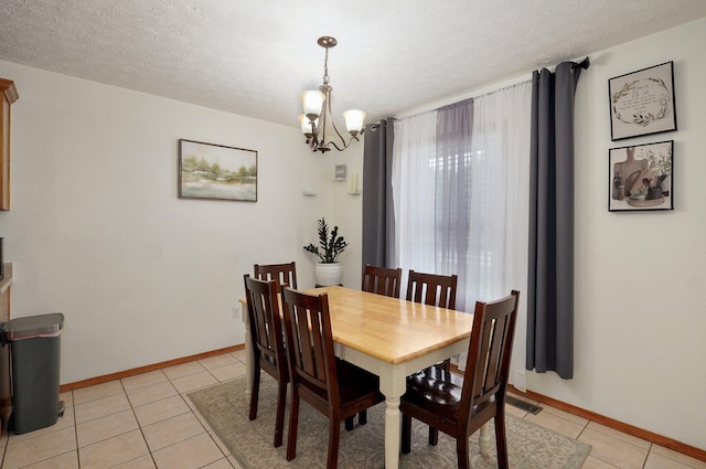 6004 N 6th Ave, Ozark, MO 65721 - dining room featuring light tile patterned flooring, a chandelier, and baseboards