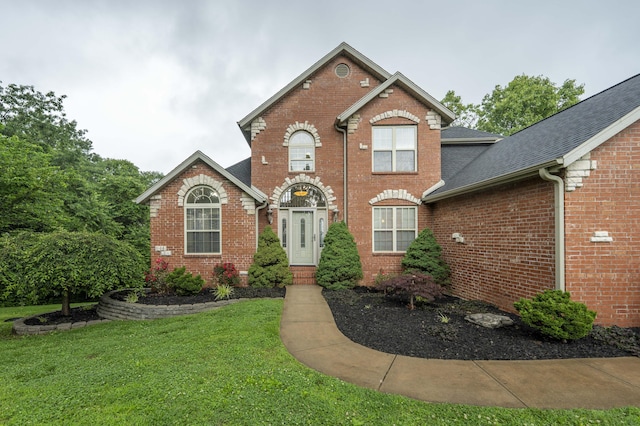287 Appletree Dr, Ozark, MO 65721 - traditional-style house featuring brick siding, a front lawn, and roof with shingles