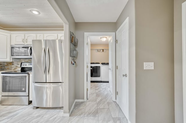 287 Appletree Dr, Ozark, MO 65721 - kitchen with stainless steel appliances, separate washer and dryer, white cabinetry, baseboards, and tasteful backsplash