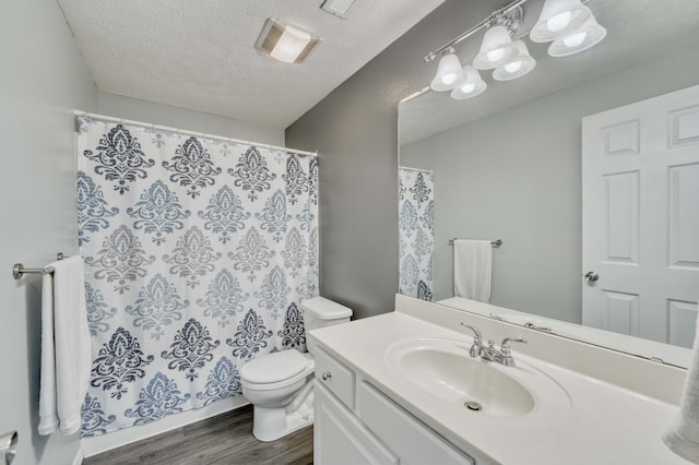 287 Appletree Dr, Ozark, MO 65721 - bathroom with wood finished floors, toilet, vanity, a textured ceiling, and a shower with shower curtain