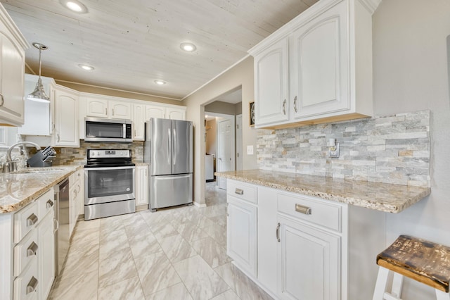 287 Appletree Dr, Ozark, MO 65721 - kitchen featuring stainless steel appliances, a sink, light stone countertops, decorative backsplash, and recessed lighting