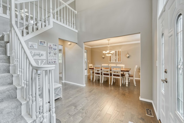 287 Appletree Dr, Ozark, MO 65721 - foyer with stairs, baseboards, wood finished floors, crown molding, and a high ceiling