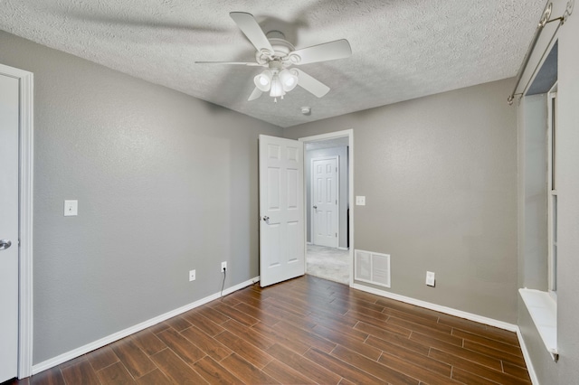 287 Appletree Dr, Ozark, MO 65721 - unfurnished bedroom with baseboards, dark wood-type flooring, a textured ceiling, and a ceiling fan