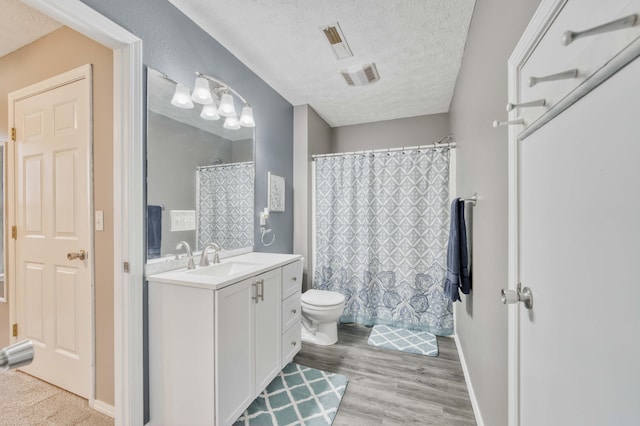 287 Appletree Dr, Ozark, MO 65721 - bathroom with a textured ceiling, vanity, toilet, wood finished floors, and a shower with curtain