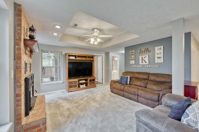 287 Appletree Dr, Ozark, MO 65721 - living room with a tray ceiling, carpet floors, a ceiling fan, baseboards, and a textured ceiling