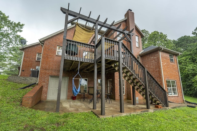 287 Appletree Dr, Ozark, MO 65721 - back of house featuring brick siding, a chimney, a patio area, a lawn, and a deck