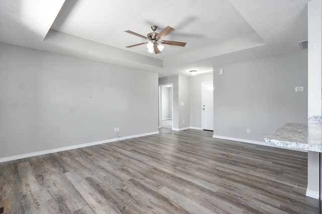 511 Mark St, Billings, MO 65610 - empty room with a raised ceiling, a ceiling fan, and wood finished floors