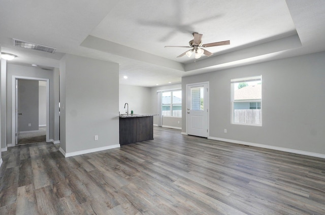511 Mark St, Billings, MO 65610 - unfurnished living room featuring ceiling fan, a raised ceiling, dark wood-style flooring, and recessed lighting