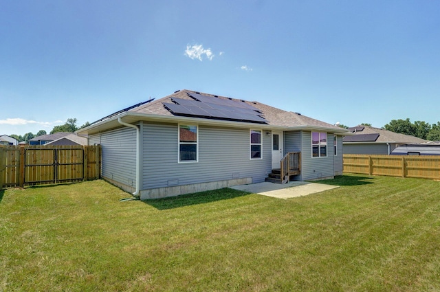 511 Mark St, Billings, MO 65610 - rear view of house featuring solar panels, a fenced backyard, and a shingled roof