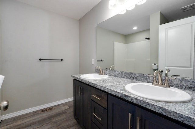 511 Mark St, Billings, MO 65610 - full bathroom featuring double vanity, wood finished floors, and a shower