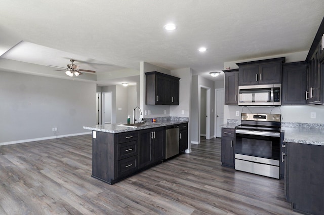511 Mark St, Billings, MO 65610 - kitchen featuring stainless steel appliances, ceiling fan, dark wood finished floors, a peninsula, and recessed lighting
