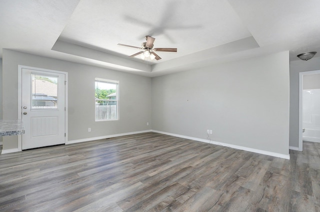 511 Mark St, Billings, MO 65610 - spare room featuring a tray ceiling, ceiling fan, and wood finished floors