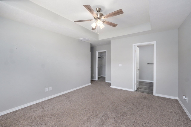 511 Mark St, Billings, MO 65610 - unfurnished bedroom with a spacious closet, carpet, a tray ceiling, a closet, and ceiling fan