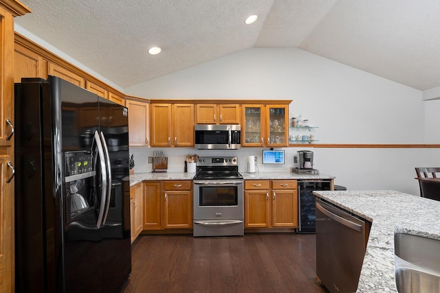 5204 W Turnberry Ct, Ozark, MO 65721 - kitchen with stainless steel appliances, wine cooler, vaulted ceiling, brown cabinets, and dark wood finished floors