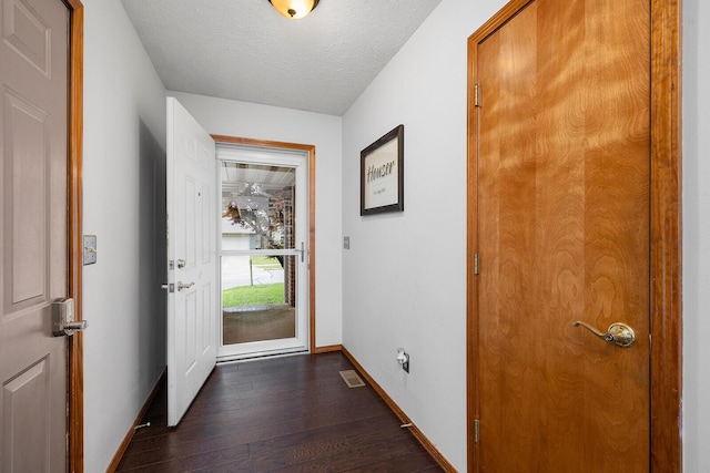 5204 W Turnberry Ct, Ozark, MO 65721 - doorway featuring baseboards, dark wood-style flooring, and a textured ceiling