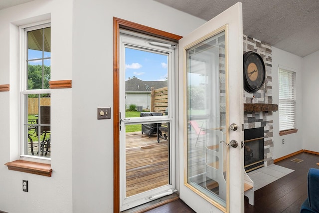 5204 W Turnberry Ct, Ozark, MO 65721 - entryway with healthy amount of natural light, dark wood-style flooring, baseboards, and a textured ceiling