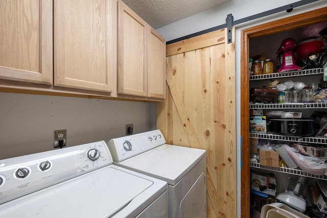 5204 W Turnberry Ct, Ozark, MO 65721 - laundry room with washer and clothes dryer, cabinet space, a textured ceiling, and a barn door