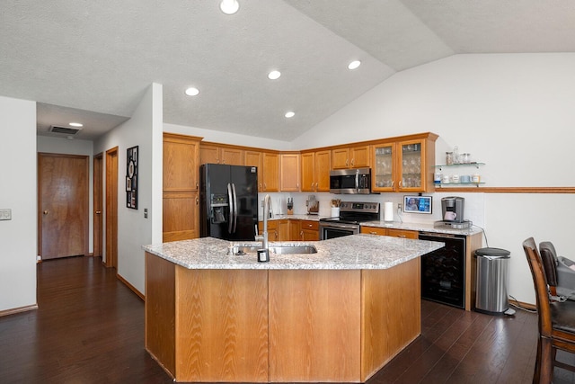 5204 W Turnberry Ct, Ozark, MO 65721 - kitchen featuring stainless steel appliances, wine cooler, a sink, vaulted ceiling, and brown cabinets