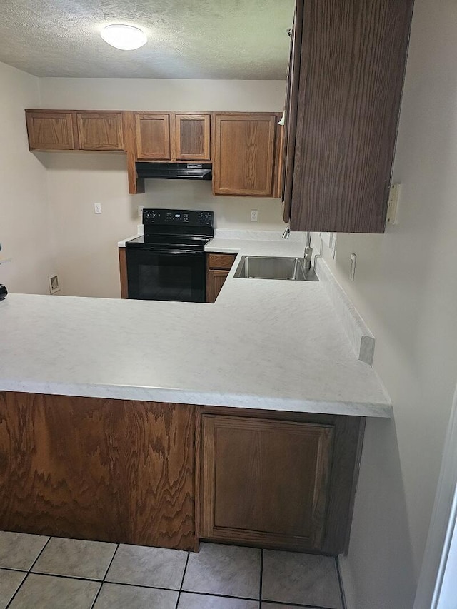 3807 S Leawood Ave, Springfield, MO 65807 - kitchen featuring under cabinet range hood, black / electric stove, a sink, light countertops, and brown cabinets