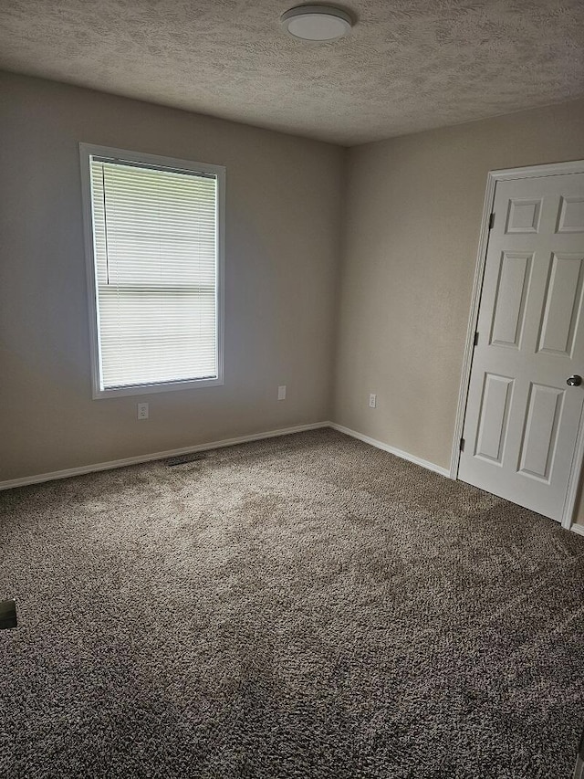 3807 S Leawood Ave, Springfield, MO 65807 - empty room with carpet floors, baseboards, and a textured ceiling