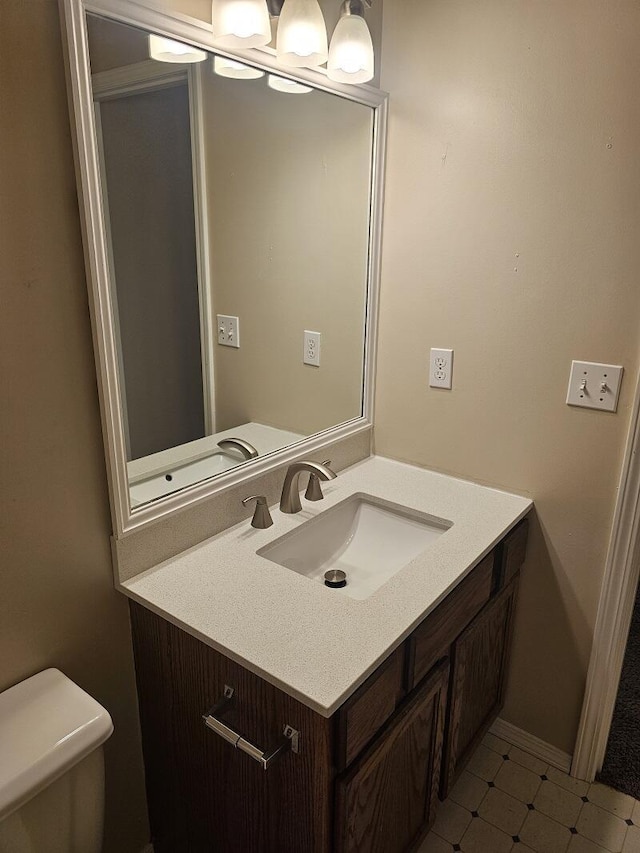 3807 S Leawood Ave, Springfield, MO 65807 - bathroom with vanity, toilet, and baseboards