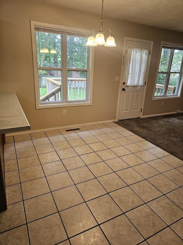 3807 S Leawood Ave, Springfield, MO 65807 - unfurnished dining area featuring a chandelier, baseboards, and tile patterned floors