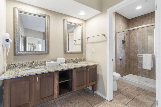 2800 Green Mountain Dr Unit 230, Branson, MO 65616 - full bathroom featuring toilet, double vanity, a stall shower, and tile patterned flooring