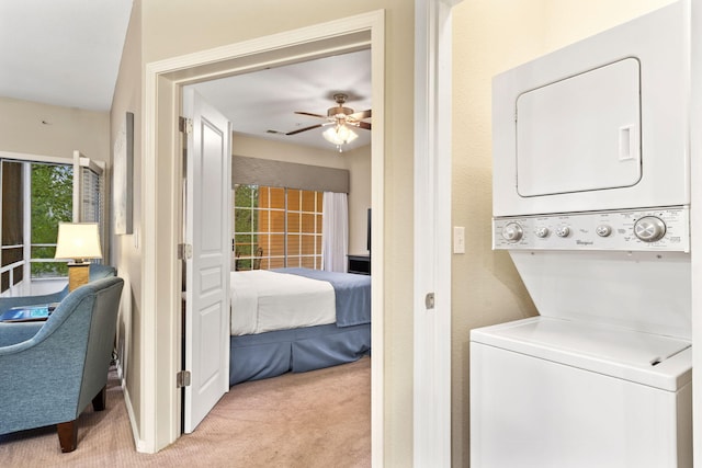 2800 Green Mountain Dr Unit 230, Branson, MO 65616 - washroom featuring stacked washer / drying machine, light colored carpet, and ceiling fan