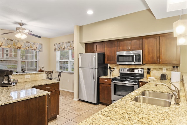 2800 Green Mountain Dr Unit 230, Branson, MO 65616 - kitchen featuring appliances with stainless steel finishes, a sink, backsplash, light stone counters, and recessed lighting