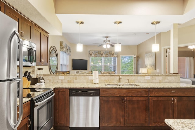 2800 Green Mountain Dr Unit 230, Branson, MO 65616 - kitchen featuring stainless steel appliances, a sink, ceiling fan, light stone counters, and a peninsula