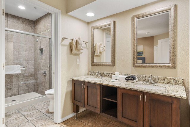 2800 Green Mountain Dr Unit 230, Branson, MO 65616 - bathroom with toilet, double vanity, a shower stall, and tile patterned flooring
