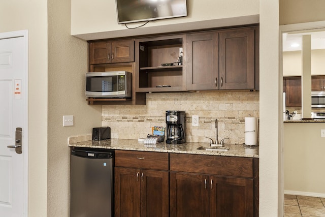 2800 Green Mountain Dr Unit 230, Branson, MO 65616 - kitchen featuring appliances with stainless steel finishes, a sink, decorative backsplash, and dark brown cabinets