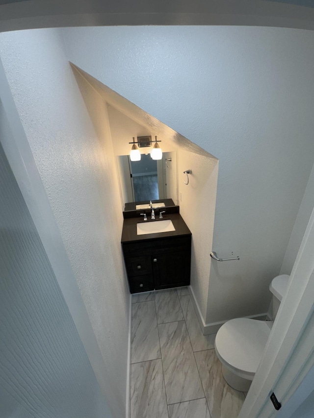 108 Jasper St, Aurora, MO 65605 - bathroom featuring marble look tiles, vanity, toilet, and baseboards