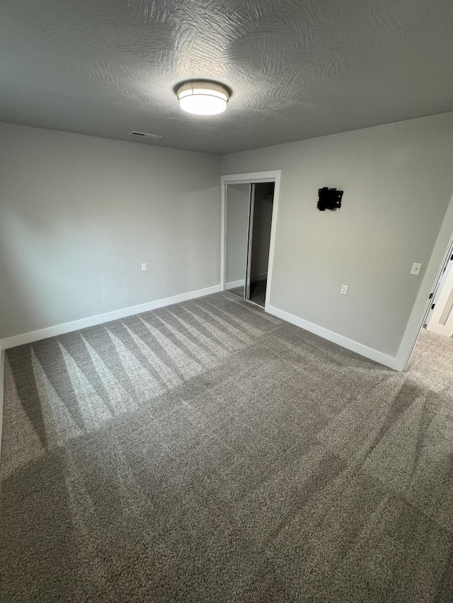 108 Jasper St, Aurora, MO 65605 - empty room with a textured ceiling, baseboards, and carpet
