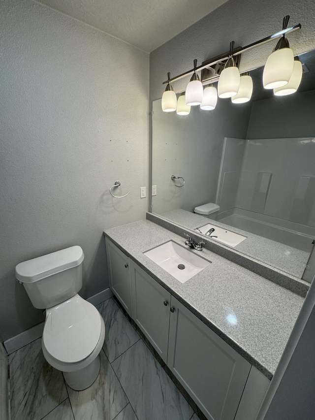 108 Jasper St, Aurora, MO 65605 - full bathroom with toilet, vanity, marble look tiles, and baseboards
