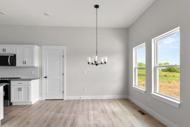 1312 N Maxine Ave, Nixa, MO 65714 - unfurnished dining area with light wood finished floors, a chandelier, and baseboards