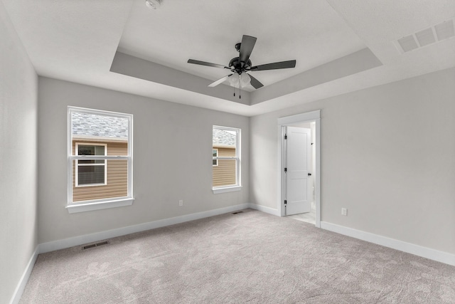 1312 N Maxine Ave, Nixa, MO 65714 - empty room featuring a tray ceiling, baseboards, and carpet