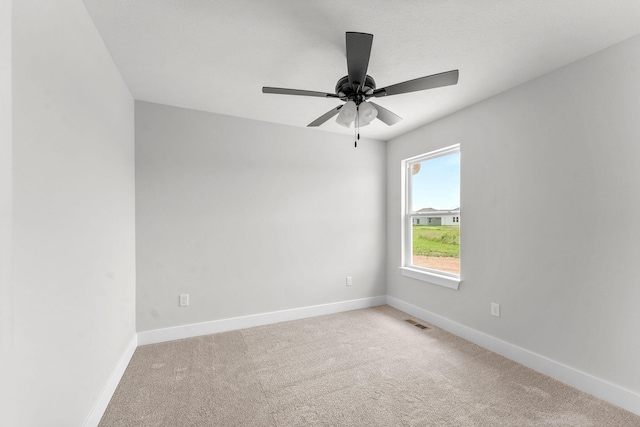 1312 N Maxine Ave, Nixa, MO 65714 - spare room with light colored carpet, a ceiling fan, and baseboards